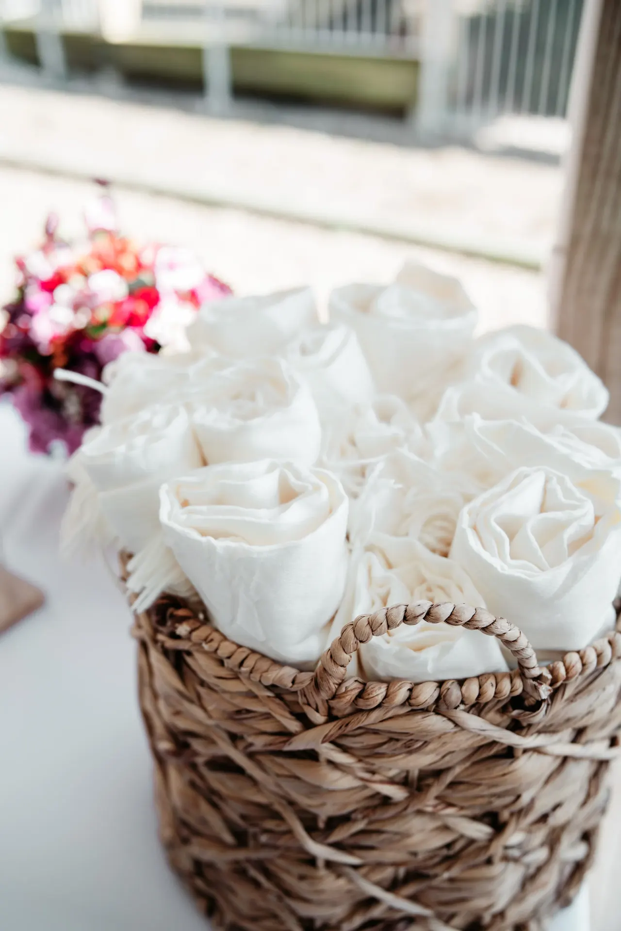 Hands holding professional camera with lens in natural lighting.
