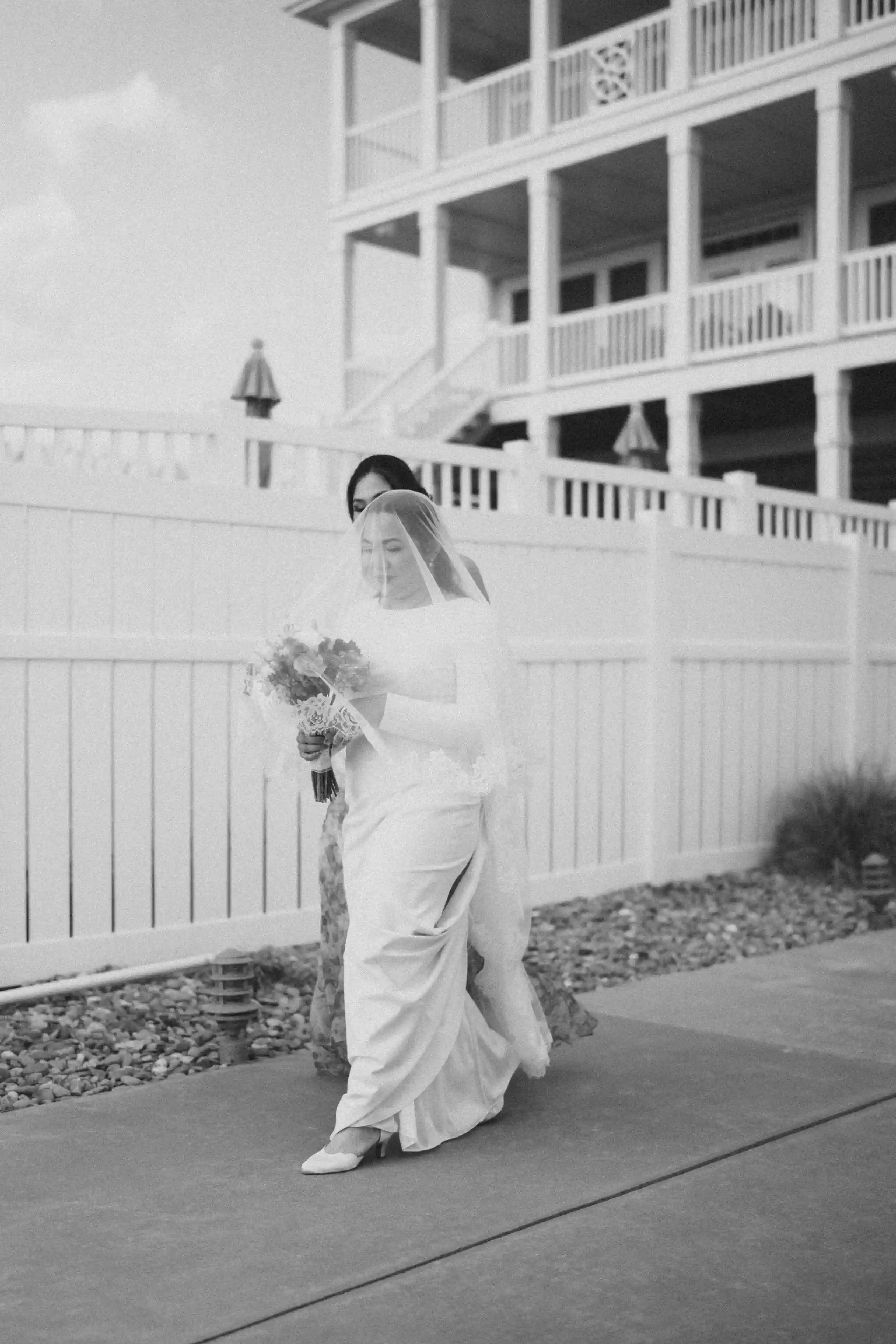 A couple embracing in foamy ocean waves during a romantic beach photoshoot.