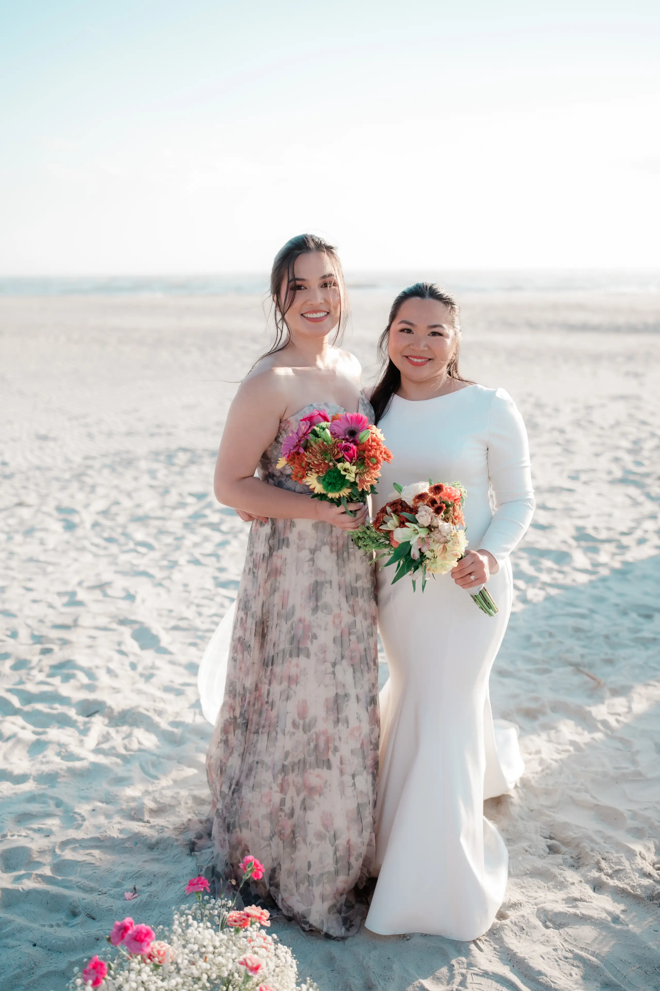 A boutonniere being pinned onto a navy suit jacket during wedding preparations.