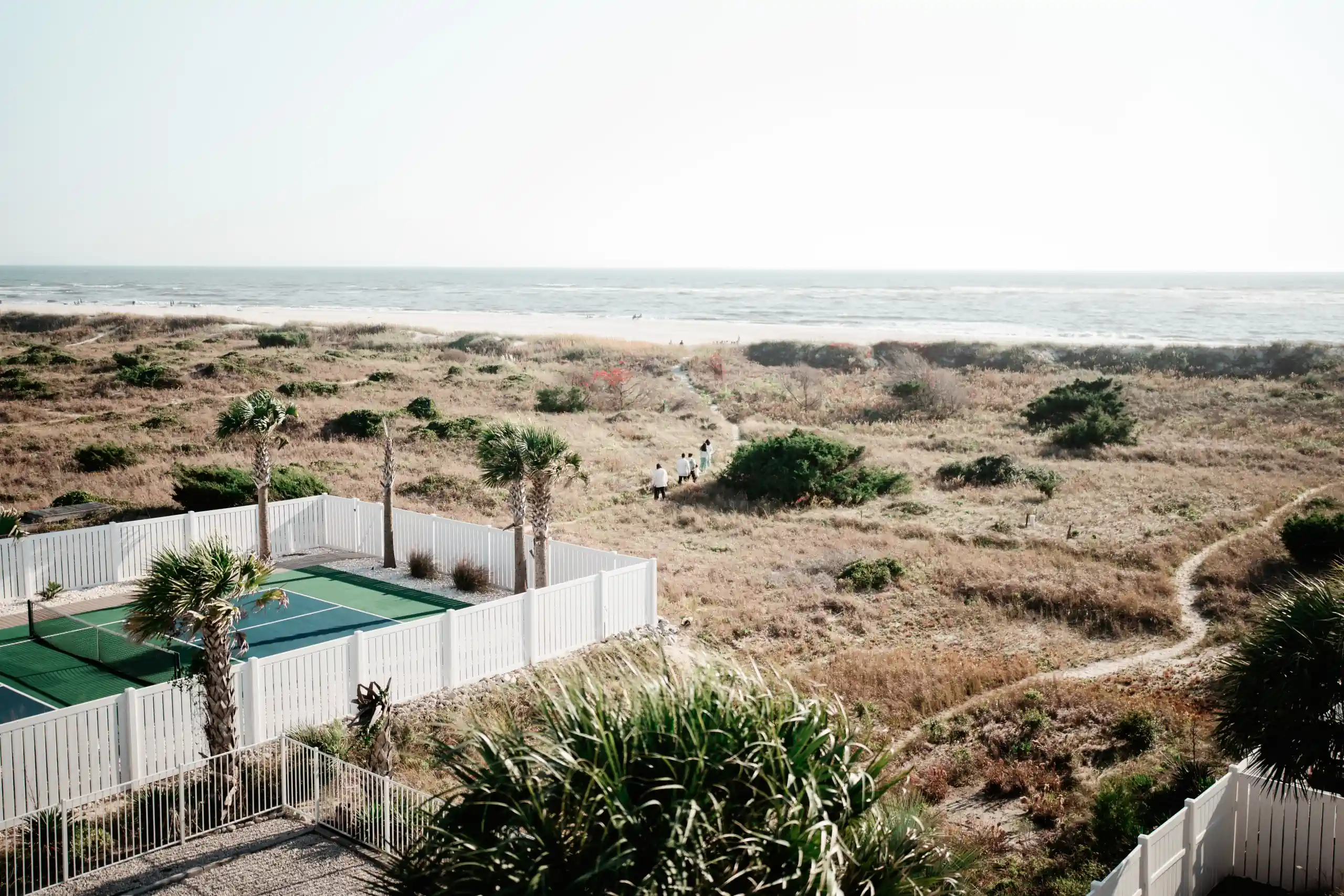 Romantic wedding portrait with couple embracing in garden setting with bridal bouquet.