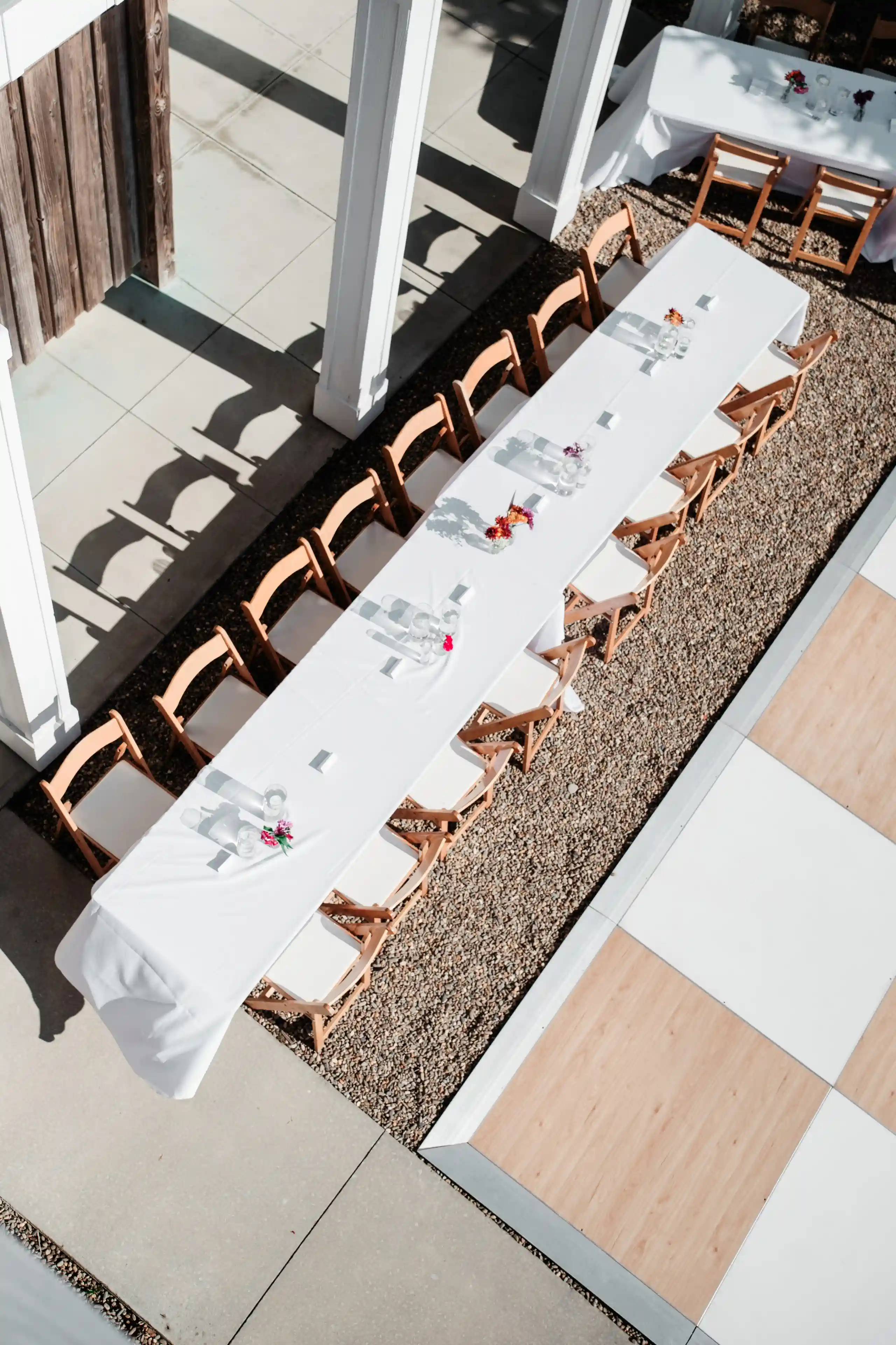 Illuminated rustic barn venue at dusk with wedding guests arriving.