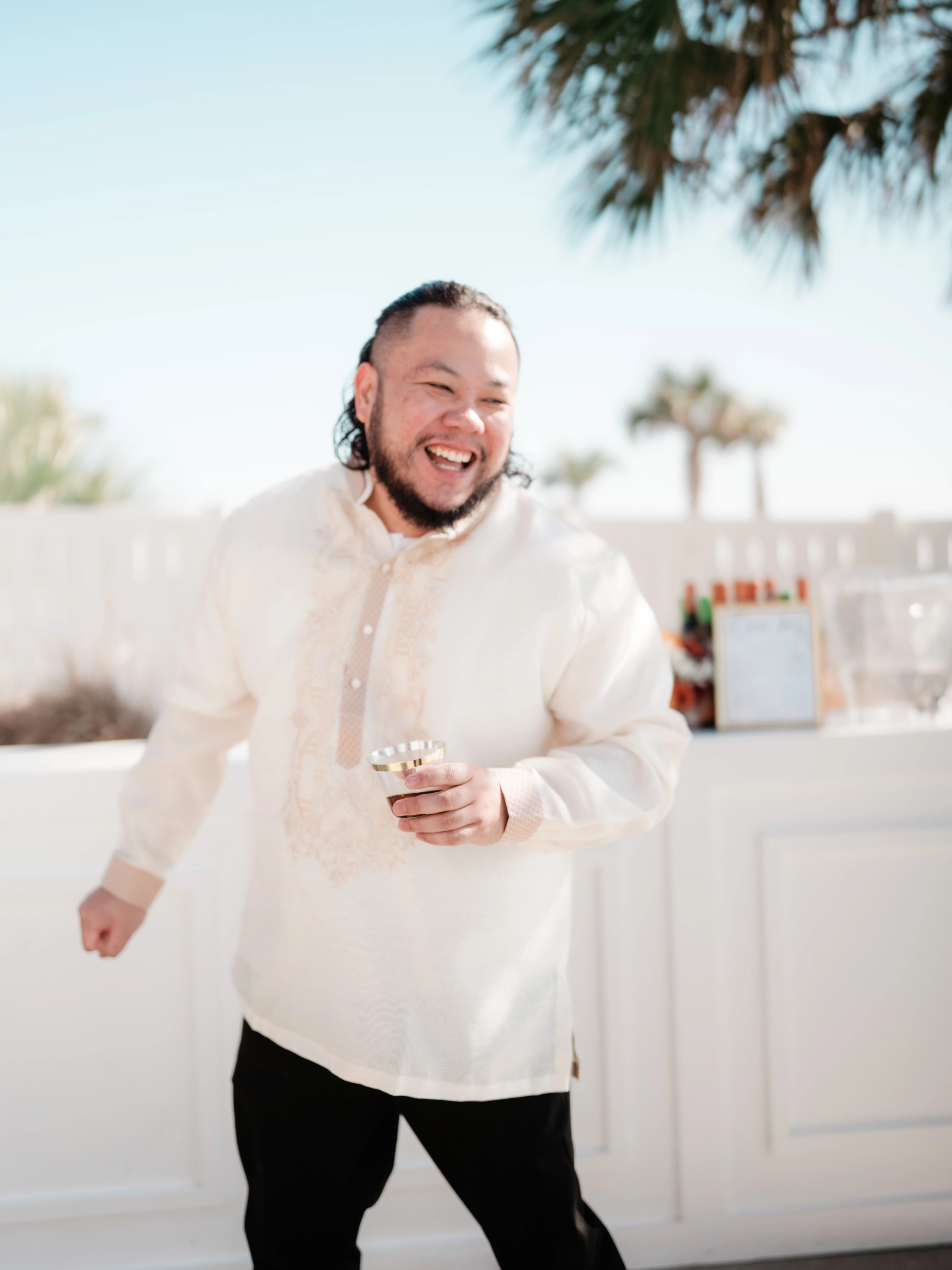 Stunning bridal bouquet with peach roses, white flowers, and blue thistles in a loose garden style.